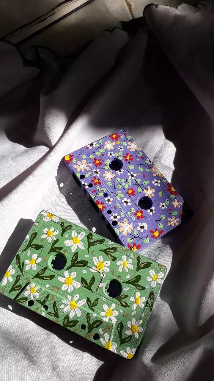 two colorful boxes sitting on top of a white sheet