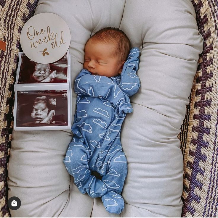 a baby is sleeping in a basket with its head on the pillow next to it