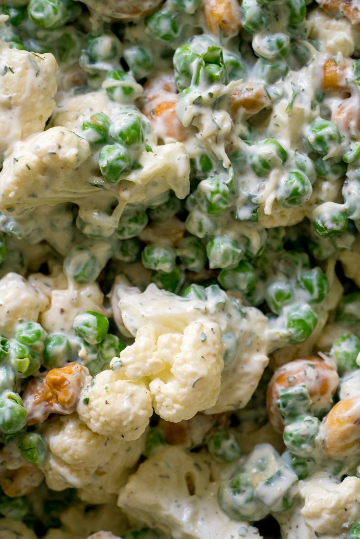 a bowl filled with broccoli and peas