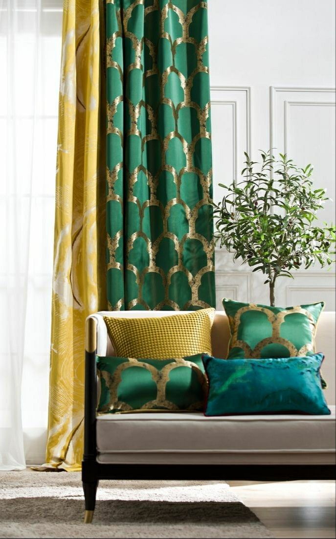 a living room with green and yellow curtains, a couch, and a potted plant