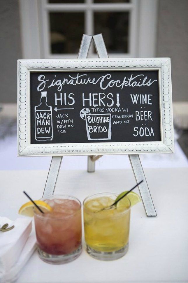 two drinks sitting on top of a table next to a sign that says, his hers wine