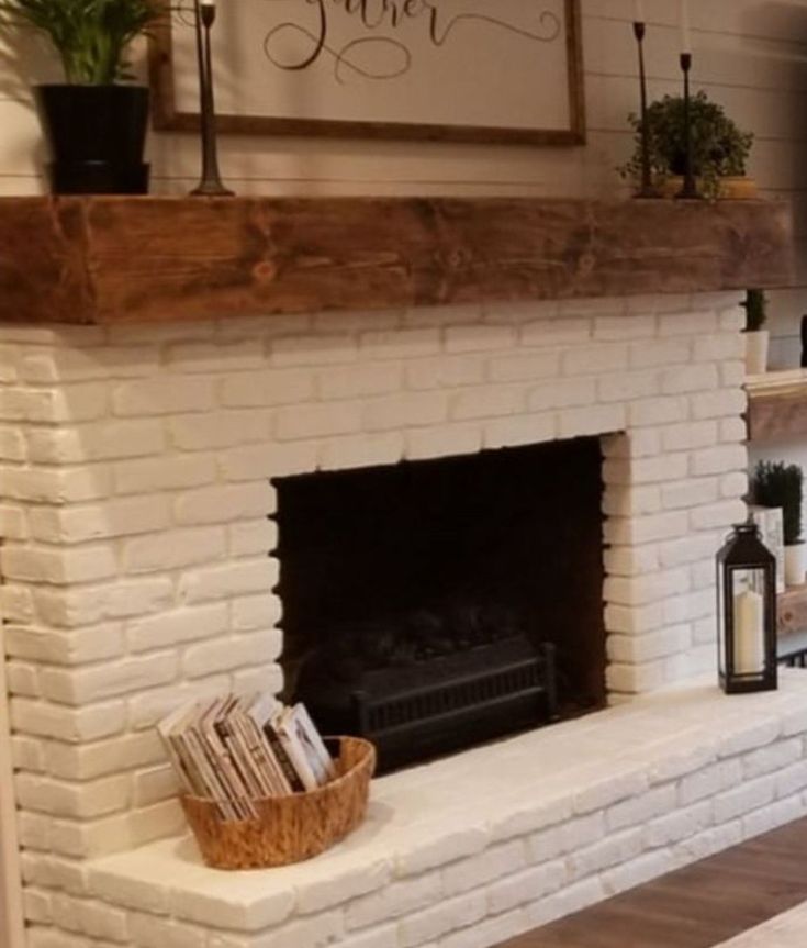 a living room with a white brick fireplace