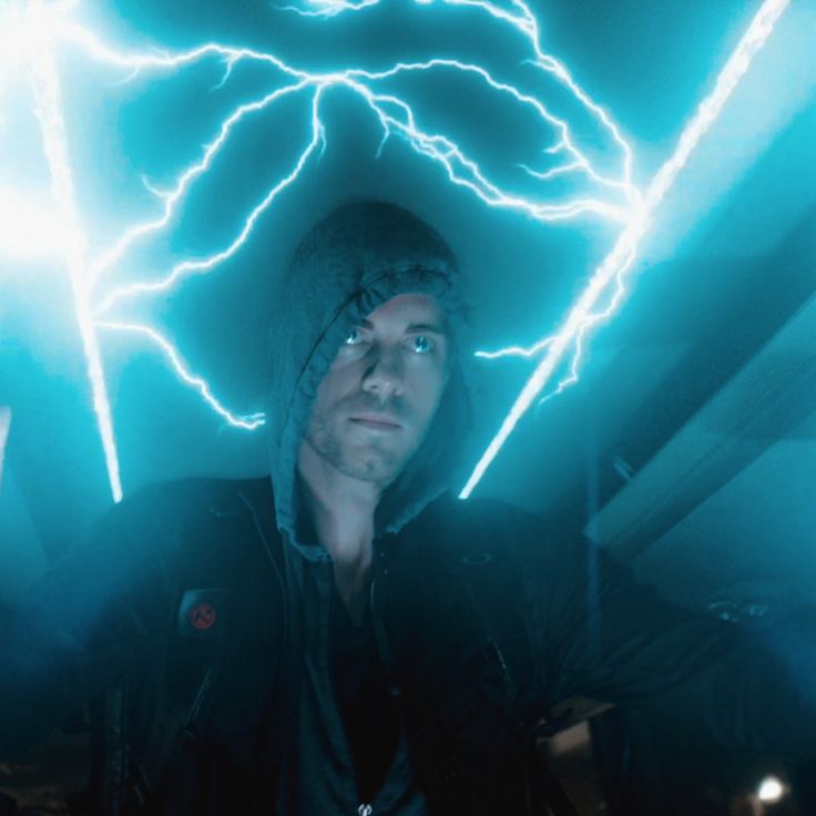 a man standing in the middle of a room with lightning coming out of his head