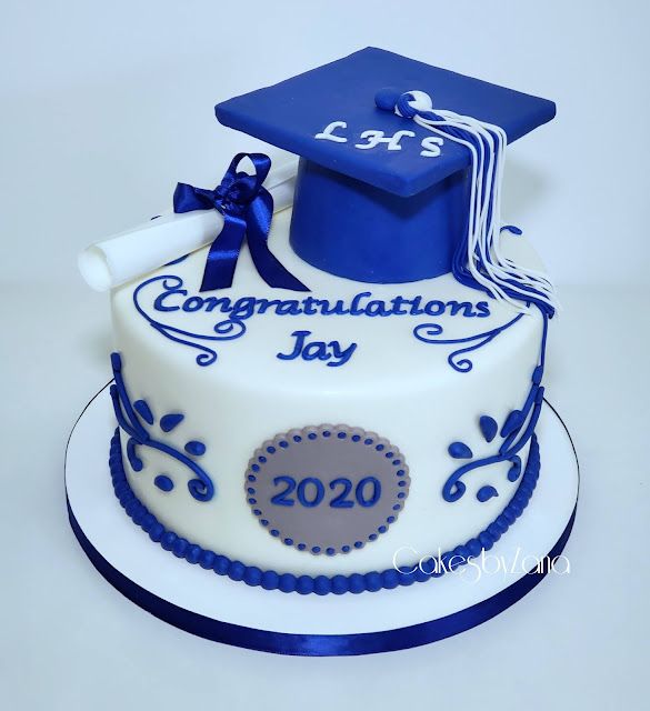 a graduation cake decorated with blue and white decorations