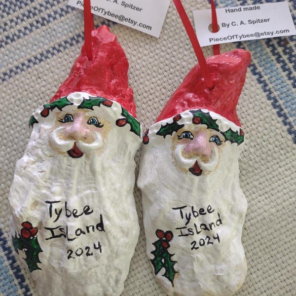 two plastic santa claus ornaments with name tags on them