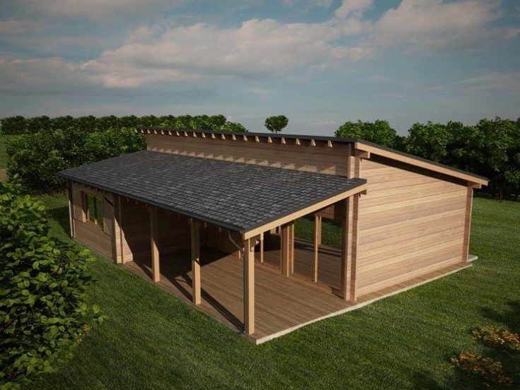 a small wooden building sitting on top of a lush green field