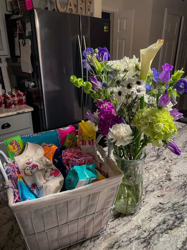 a basket filled with flowers sitting on top of a kitchen counter next to a refrigerator