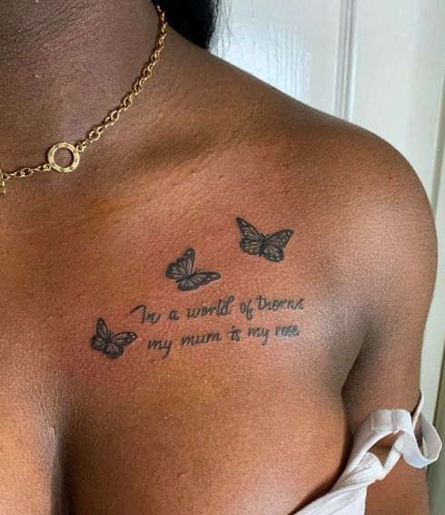 a woman's chest with butterflies on it that says, i'm a world of dreams my mum is my son