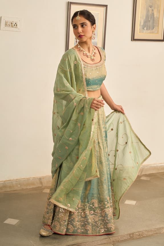 Turquoise lehenga with zardozi embroidered floral motifs. Comes with matching blouse and gota lace embellished dupatta. - Aza Fashions Chanderi Sets With Sheer Dupatta For Reception, Unstitched Chanderi Lehenga For Reception, Bollywood Tissue Silk Sets With Cutdana, Bollywood Style Cutdana Tissue Silk Sets, Reception Palazzo Set With Sheer Dupatta In Dola Silk, Designer Tissue Silk Set With Dori Work, Eid Tissue Silk Lehenga With Sheer Dupatta, Sheer Dupatta Palazzo Set For Reception, Eid Tissue Silk Lehenga With Dupatta