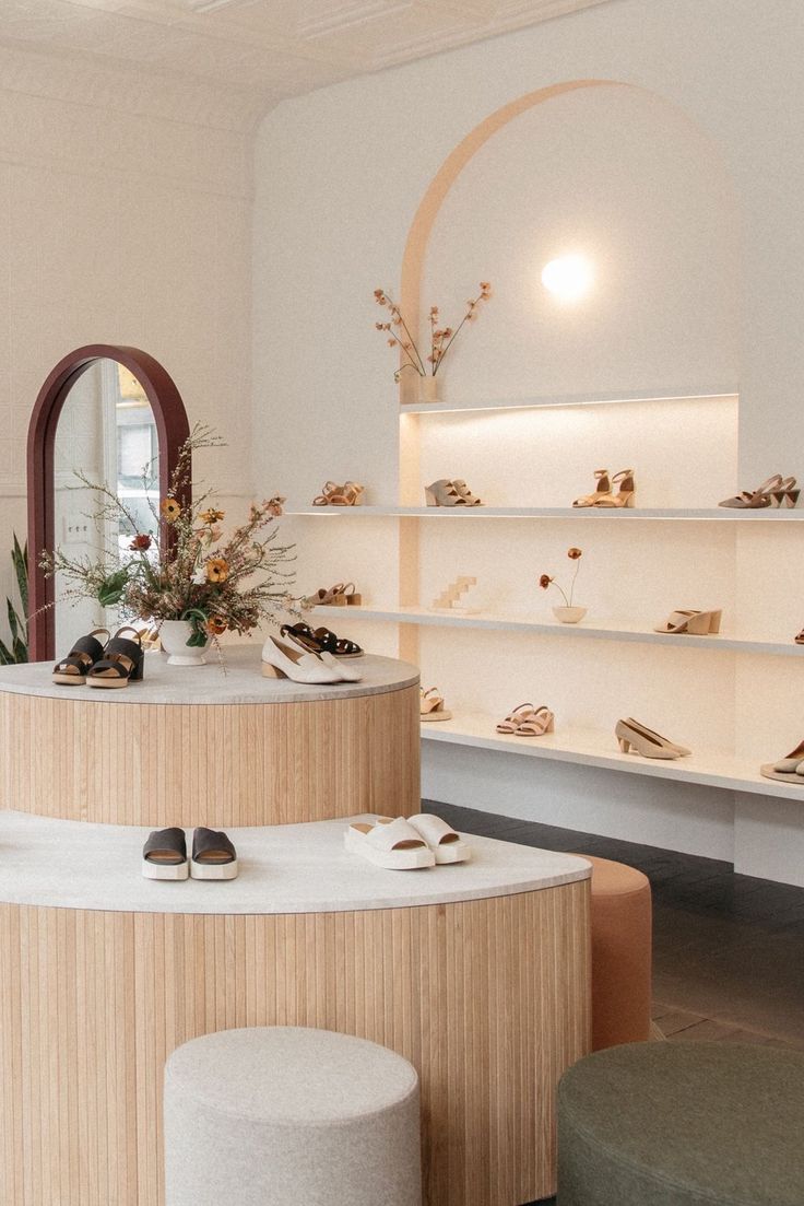 the inside of a shoe store with shoes on display