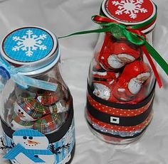 two glass jars filled with candy sitting on top of a white sheet covered table next to each other