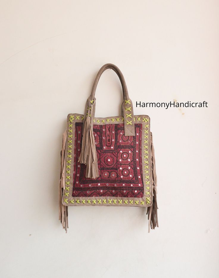 Welcome to HarmonyHandicraftCo Banjara shoulder bag is large enough to hold everything you need throughout your day, Made of antique hand-embroidered Banjara Patch and Leather Thread textiles, with intricate embellishments, bag is truly unique. Size in Inches ( Approx ) Height with handle -25 Height - 16" Width - 15" Sides - 4" Inside Pocket - 3 Outside Pocket - No Closure - Zipper This Bag is made from Leather and hand embroidered Kutchi tribal fabrics which features multi color mirror work, sequins, Beautiful patchwork of colorful hand embroidered work. These multi color cotton shoulder bags are brilliantly embroidered with leather strap. Very colorful and striking color purse, It can be a unique gift for girls, girl friends, sisters, daughters. Housewives, and can a perfect match with a Traditional Leather Shoulder Bag, Traditional Satchel For Everyday Use, Traditional Shoulder Satchel For Daily Use, Traditional Handmade Satchel Hobo Bag, Traditional Handmade Hobo Satchel Bag, Bohemian Hand-stitched Satchel For Daily Use, Traditional Rectangular Shoulder Bag For Everyday Use, Traditional Tote Satchel For Daily Use, Traditional Handmade Hobo Tote Bag