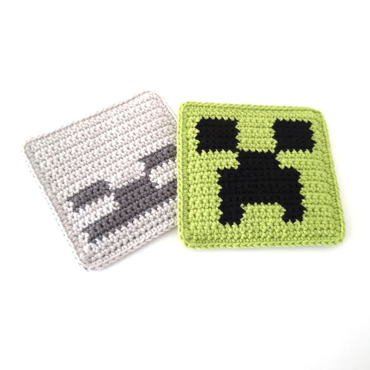 two crocheted coasters with black and white squares on them, one has a dog