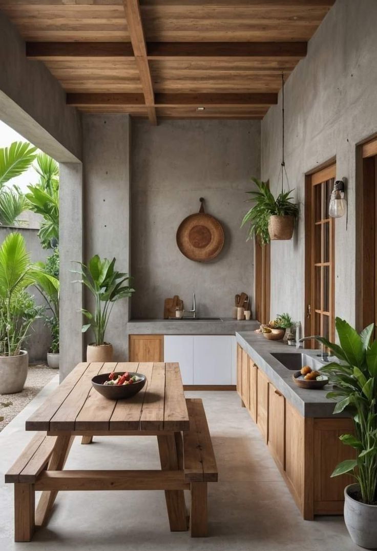 a wooden table sitting in the middle of a kitchen next to a sink and window