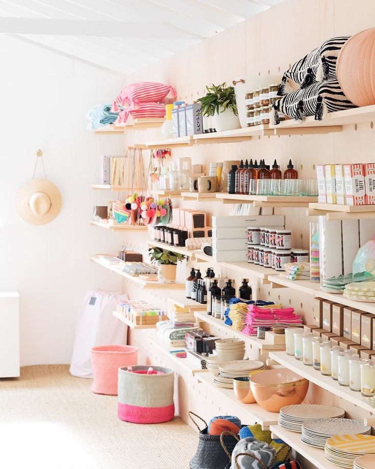 a room with shelves filled with lots of crafting supplies and crafts on the walls