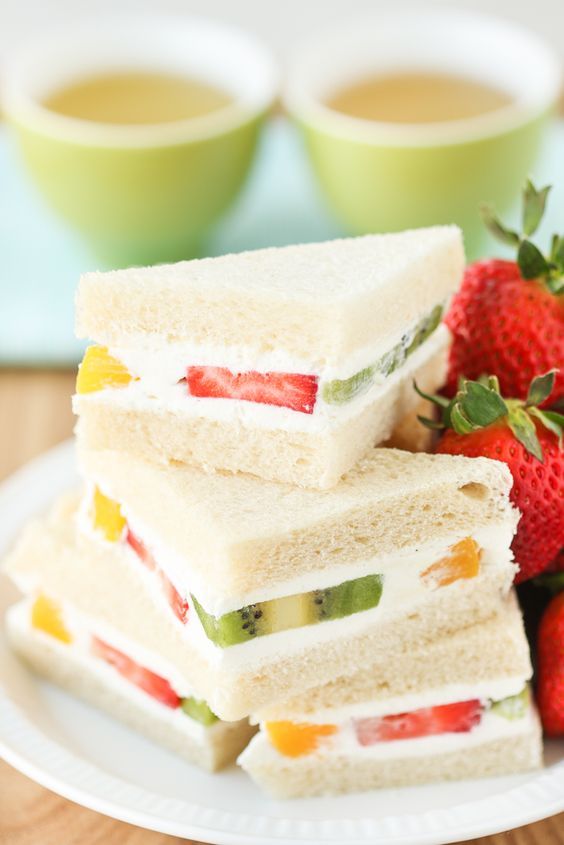 there are four different slices of cake with fruit on top and in the middle one is cut into pieces