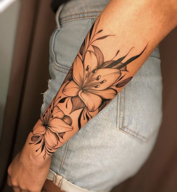 a woman's arm with flowers on it