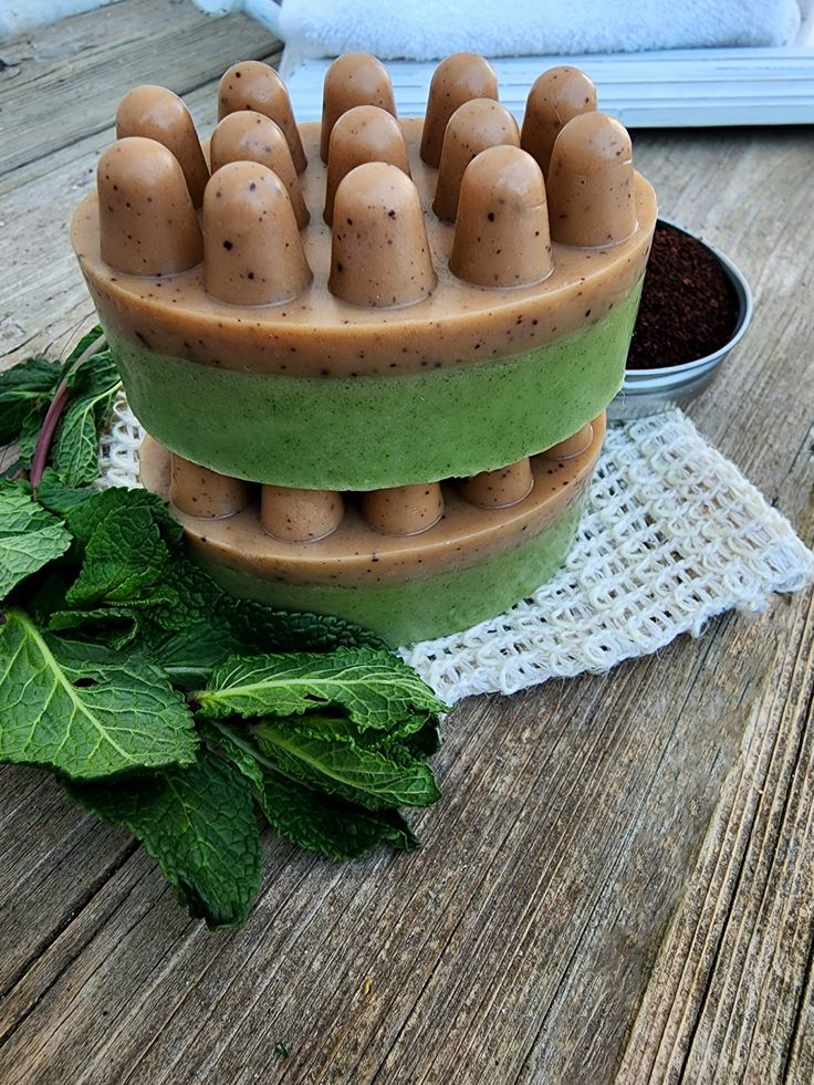 two bowls filled with different types of food on top of a wooden table next to green leaves