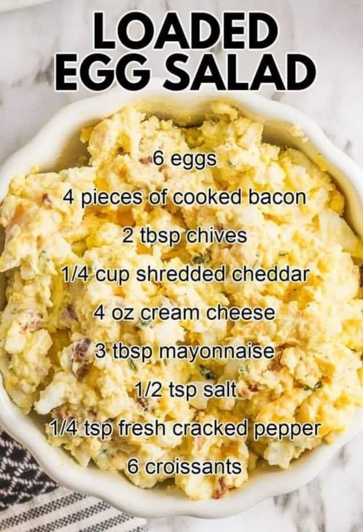 the ingredients for loaded egg salad in a white bowl on a marble counter top with text overlay