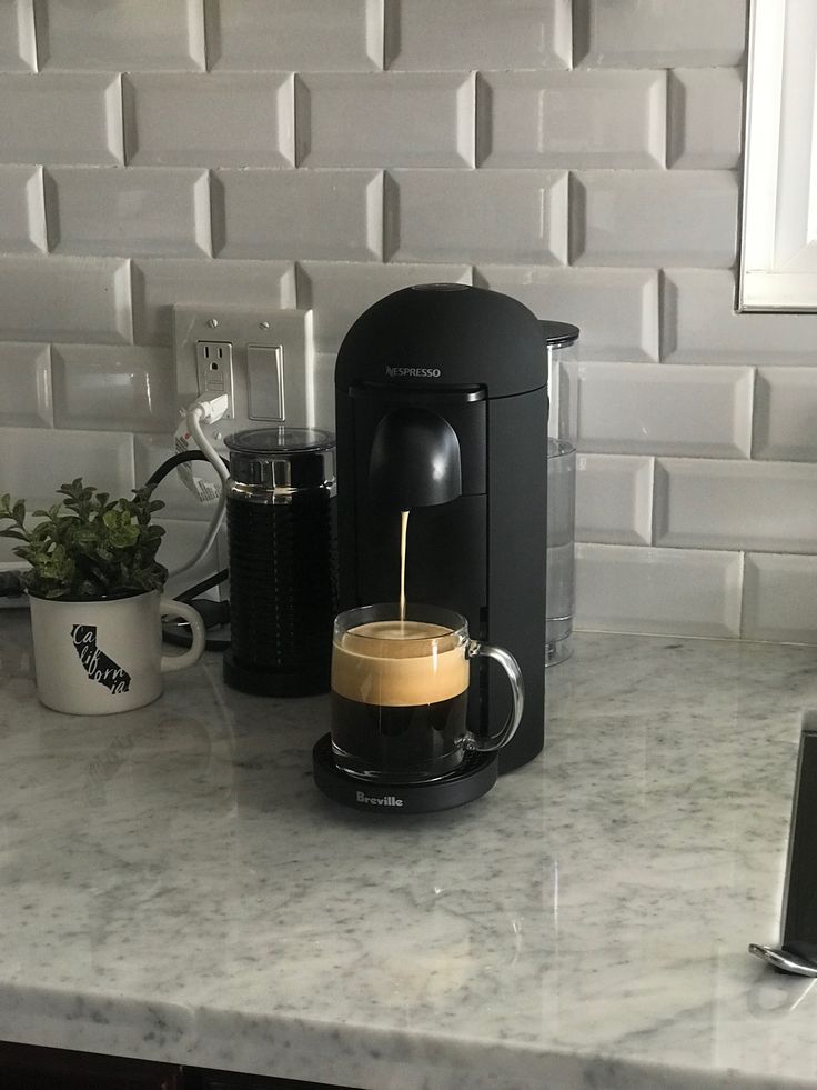 a coffee maker is being filled with liquid