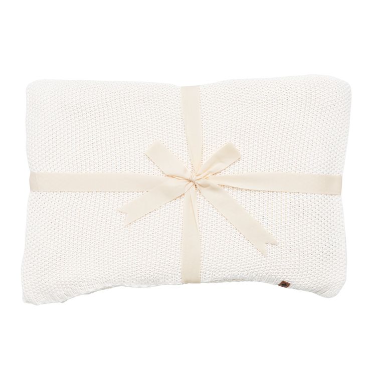 a white pillow with a bow on it