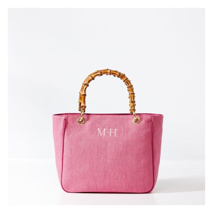 This stunning summer-inspired handbag, now in a compact, vacation-ready size, is crafted from a durable raffia-inspired fabric with polished bamboo handles. Lined in cotton with three interior pockets and polished bamboo handles, the classic silhouette is both simple and elegant, polished enough for formal occasions and relaxed enough for everyday use. Embroider a monogram to add a personal touch to this luxe gift for yourself or your favorite person.    12" w (bottom) x 5" d x 10.5" h  Handle d Summer Rectangular Bag With Bamboo Handle, Summer Bag With Bamboo Handle And Rectangular Shape, Luxury Travel Bags With Bamboo Handle, Summer Bags With Bamboo And Double Handles, Chic Double Handle Beach Bag With Bamboo Handle, Straw Beach Bag With Bamboo Handle For Travel, Shopping Bag With Bamboo Handle And Top Handle, Luxury Straw Bag With Bamboo Handle For Spring, Luxury Spring Straw Bag With Bamboo Handle