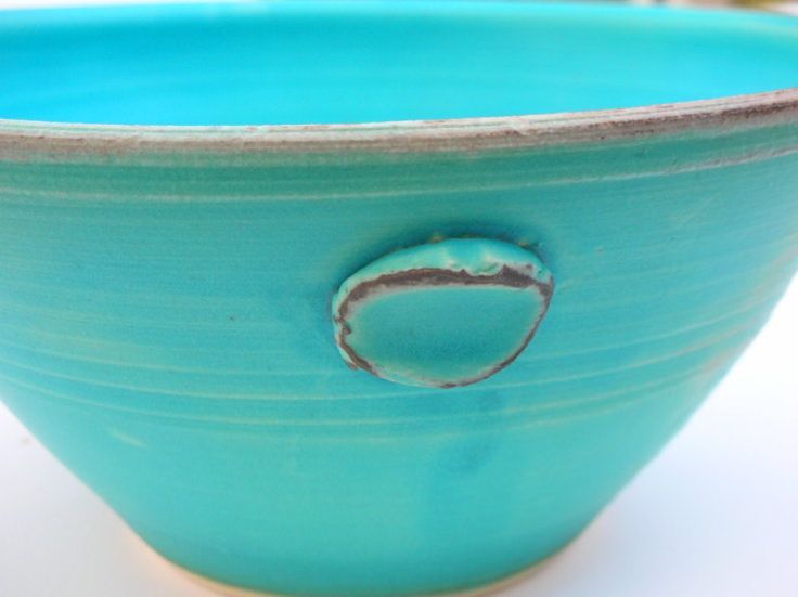 a blue bowl with a hole in the middle