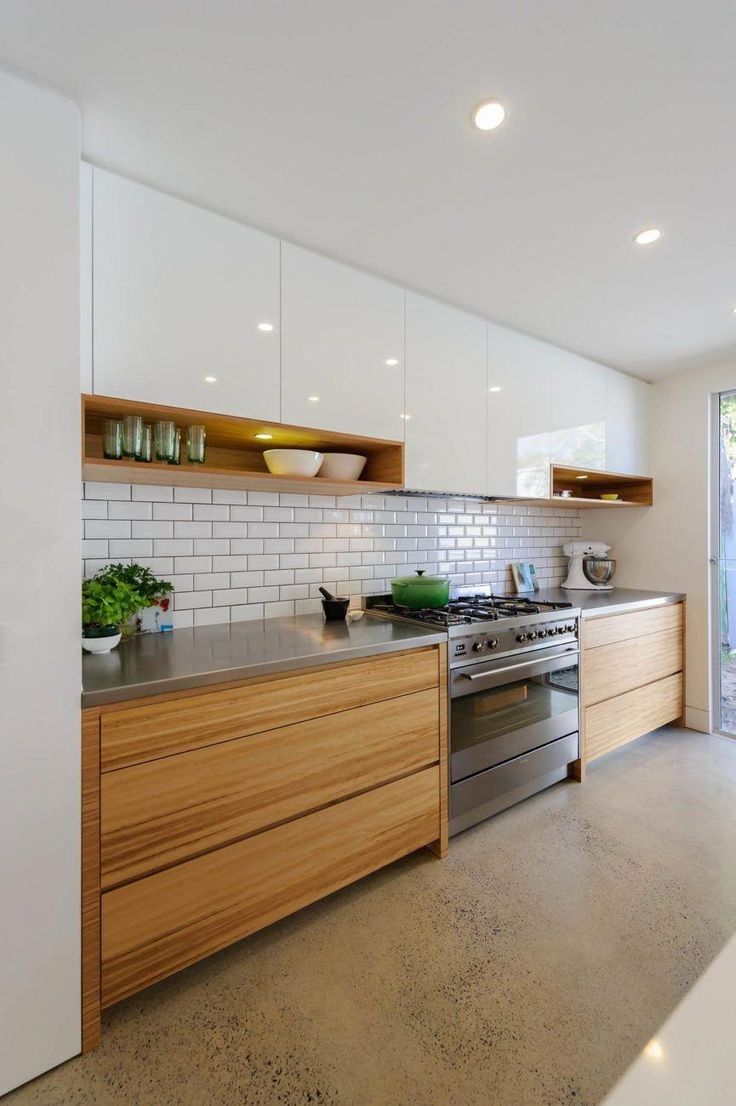 a kitchen with an oven, sink and counter top in the middle of the room