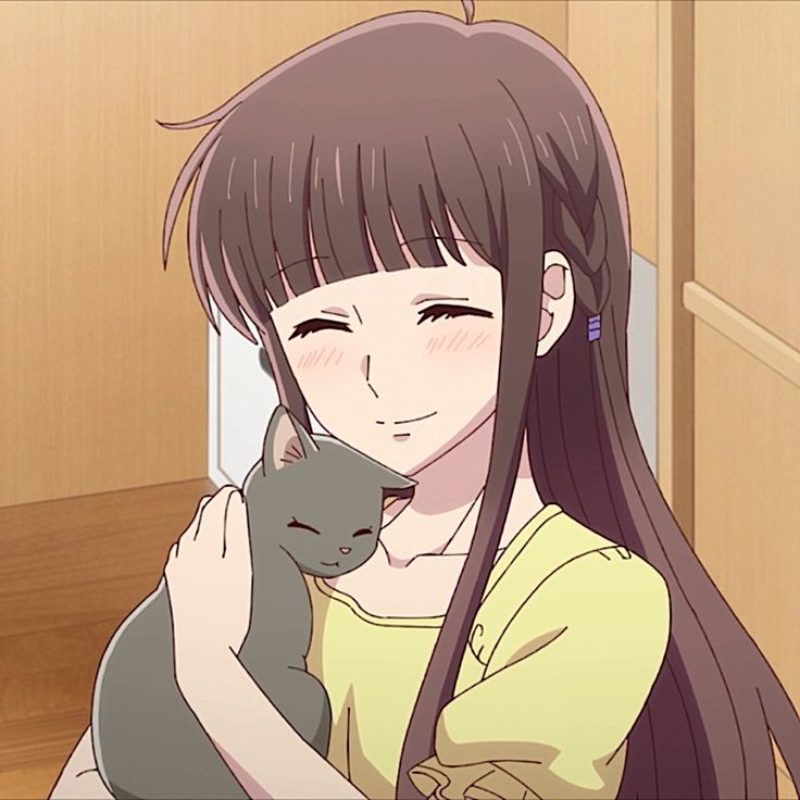 a girl with long hair holding a cat