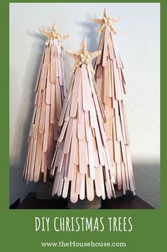 two wooden christmas trees on top of a table with the words diy christmas craft