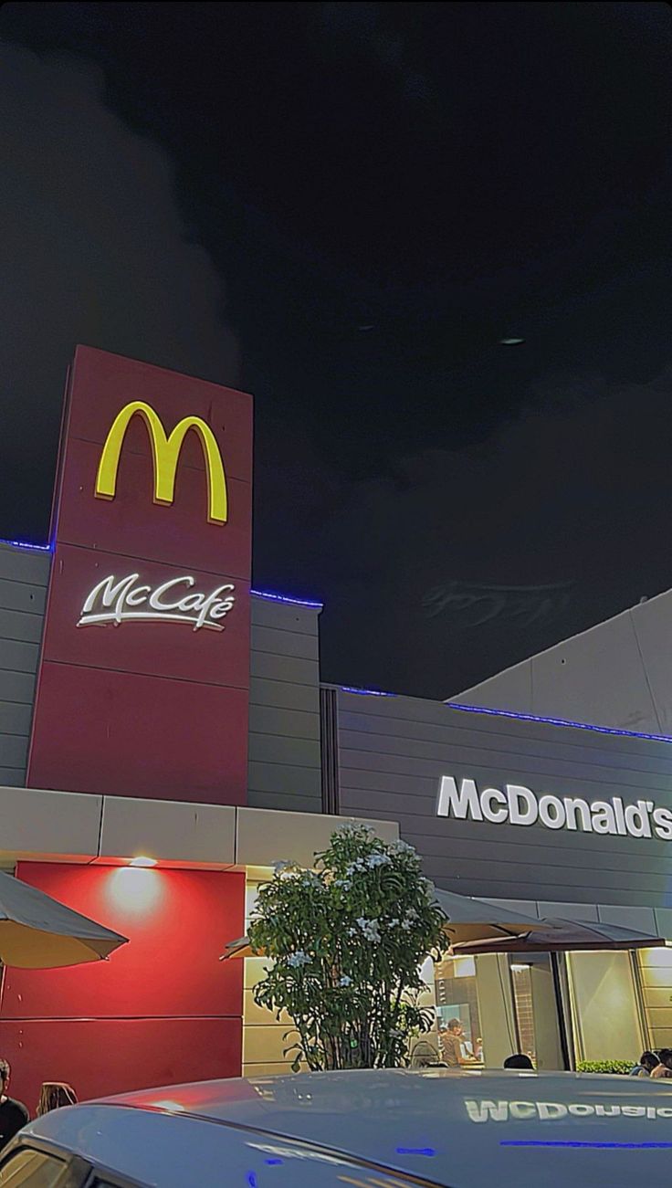 a mcdonald's restaurant is lit up at night