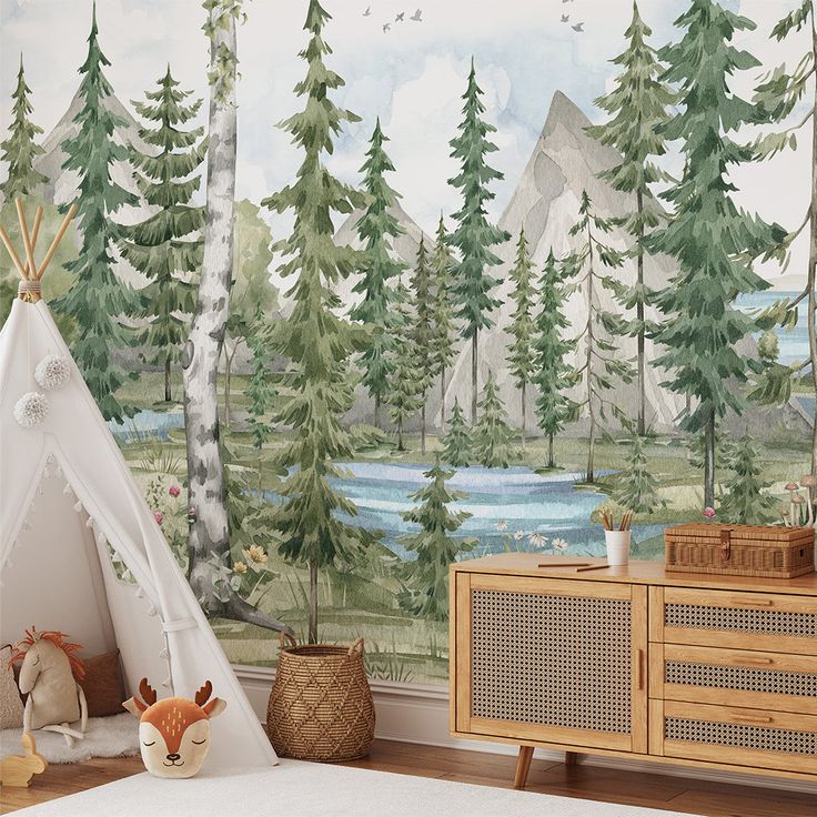 a child's room with a teepee tent and trees painted on the wall