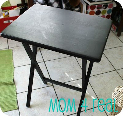 a black table sitting on top of a tiled floor