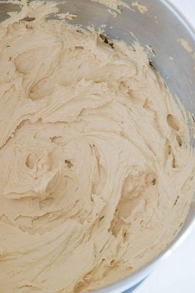 a metal bowl filled with batter on top of a table