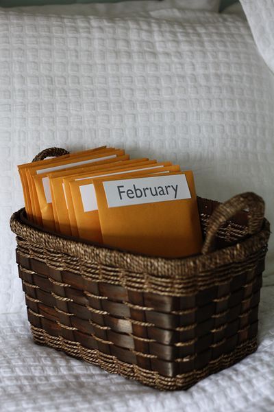 a basket filled with books on top of a bed