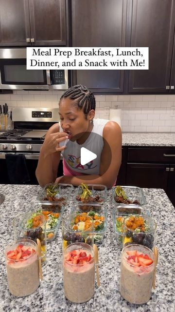 a woman sitting at a kitchen counter with several containers of food in front of her