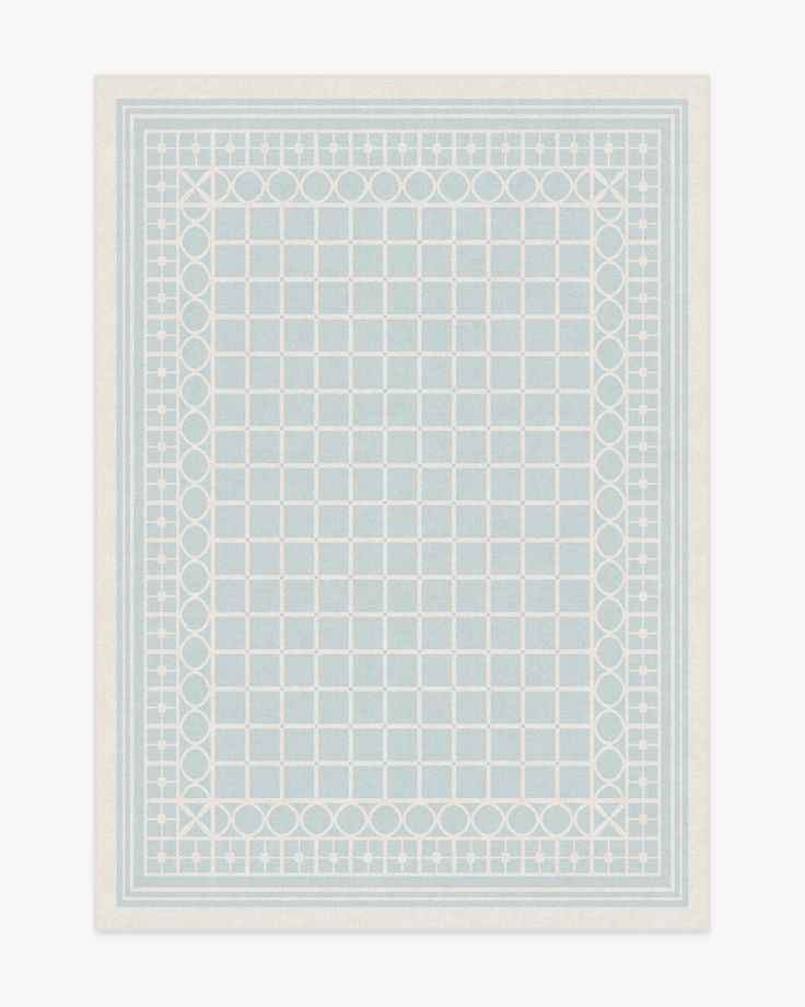 a blue and white square rug with circles on the border, in front of a white background