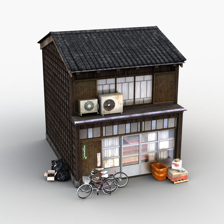 a small house with bicycles parked in front of it and two speakers on the roof