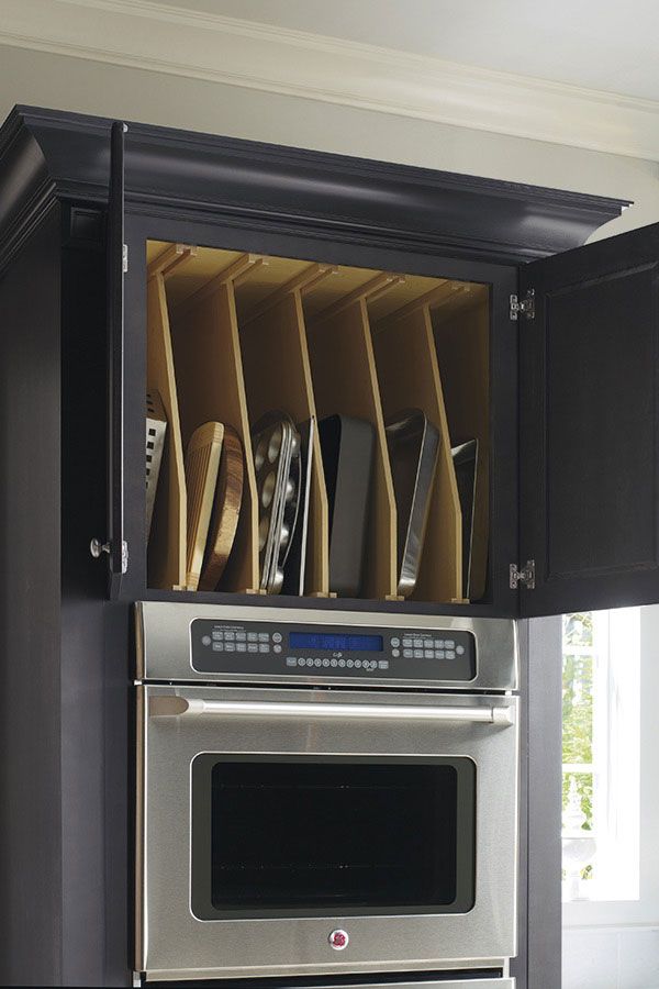 the kitchen cabinets are open with knives and pans in them on top of each other