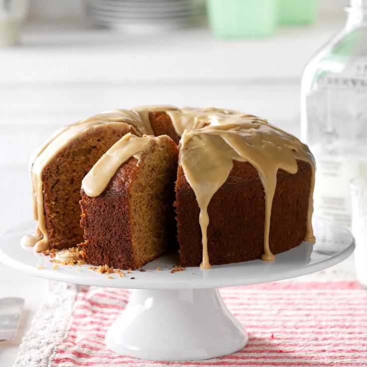 a bundt cake with icing on a white plate