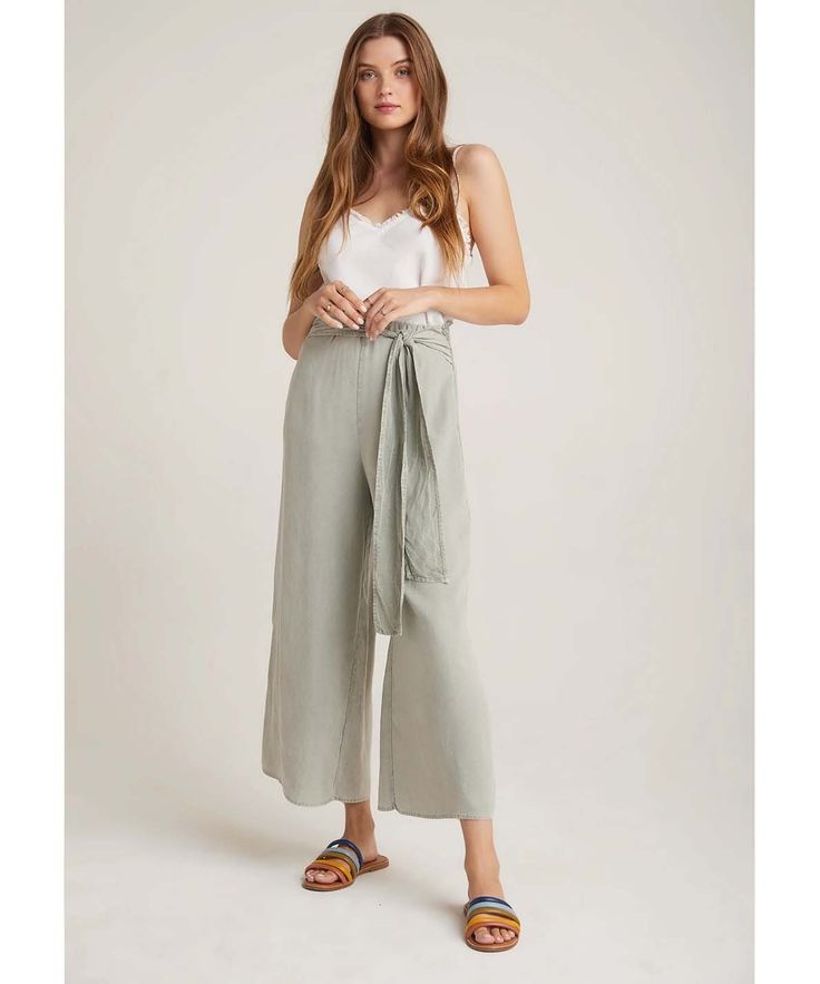 Be carefree in the Tie Waist Wide Leg Crop Pant, flowing wide-leg pants with a high-rise smocked-back tie waist and fray hem detailing. Comes in signature Soft Touch Tencera™. 100% Tencel. Made in Los Angeles 100% Tencel Machine wash cold Elasticized smocked waist with attached belt Model is 5'10"and wearing a S Waist: 27" Waist to hem: 35" Inseam: 24" High Waisted Cropped Pants, Ethical Fashion Brands, Wide Leg Cropped Pants, Small Waist, Ethical Fashion, Beautiful Outfits, Wide Leg Trousers, Cropped Pants, Favorite Outfit