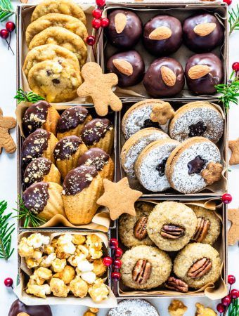 a box filled with lots of different types of cookies and pastries on top of a table