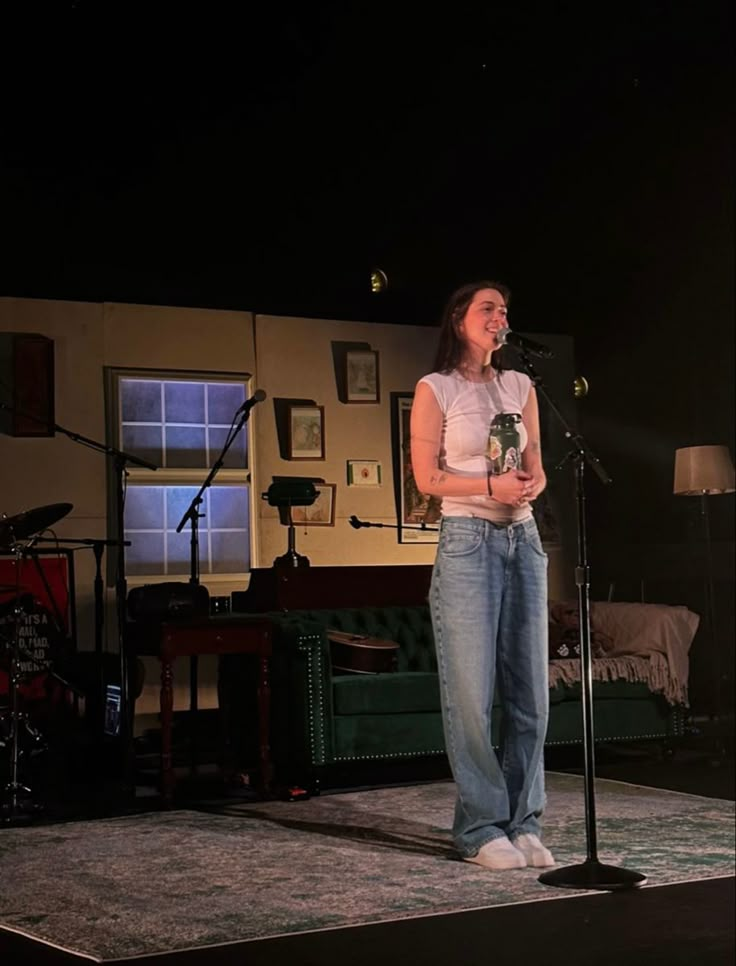 a woman standing in front of a microphone