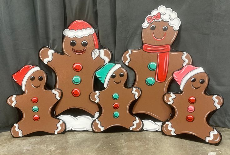 three gingerbread men are standing next to each other