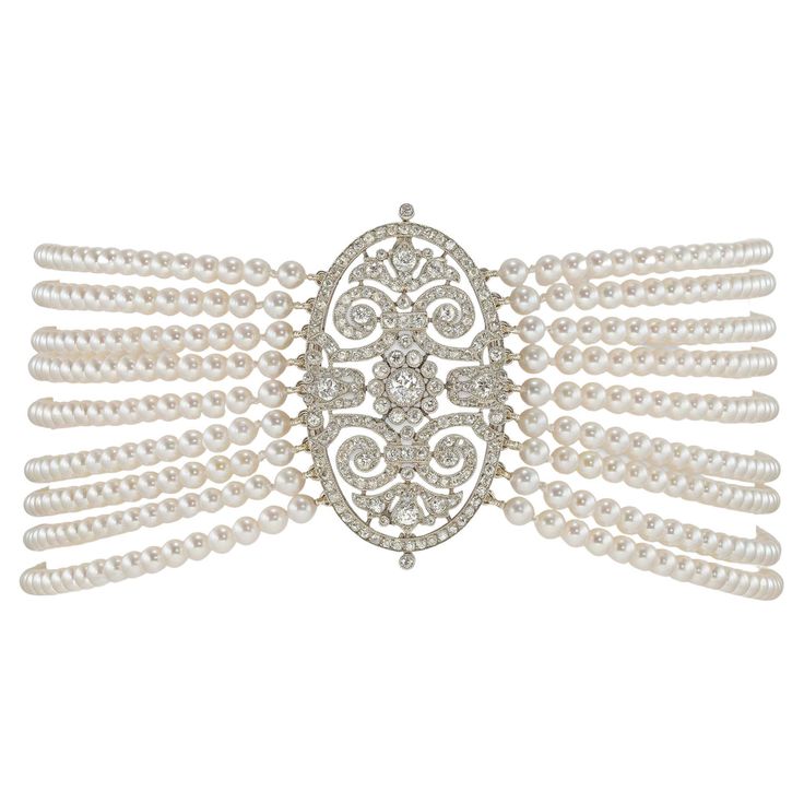 A diamond and cultured pearl chocker necklace, the Edwardian diamond centerpiece with openwork scroll design decorations, set with old European cut diamonds estimated to weigh in total approximately 4 ¾ carats, all millegrain-set in platinum, circa 1910, strung with nine rows of cultured pearls measuring 3.5-4mm n diameter, to a bayonet-style clasp, accompanied by detachable brooch fitting, the centerpiece measuring 4.4 x 2.6cm, the necklace measuring 34 x 3.3cm, gross weight 70 grams. This anti Ballet Necklace, Rock Crystal Necklace, Diamond Centerpiece, Amber Bead Necklace, Natural Pearl Necklace, Pearl And Diamond Necklace, Chocker Necklace, Gold Link Chain, Cultured Pearl Necklace