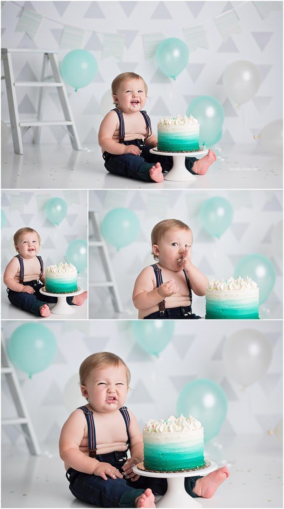 a baby sitting in front of a cake with balloons