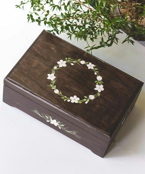 a wooden box sitting next to a potted plant