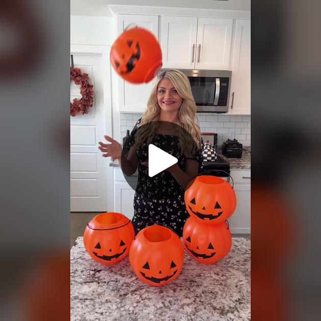 a woman juggling pumpkins in the kitchen