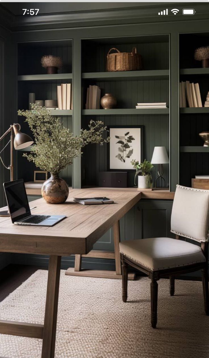 a home office with built in bookshelves and desk