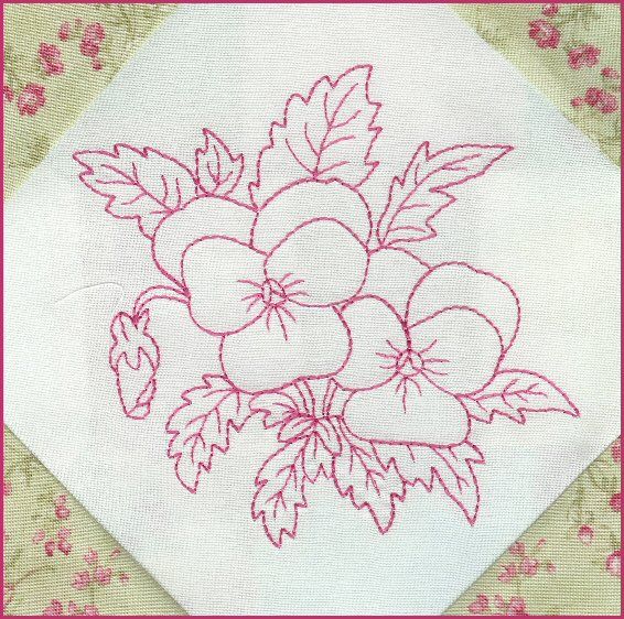 a close up of a piece of cloth with embroidery on it and flowers in the middle